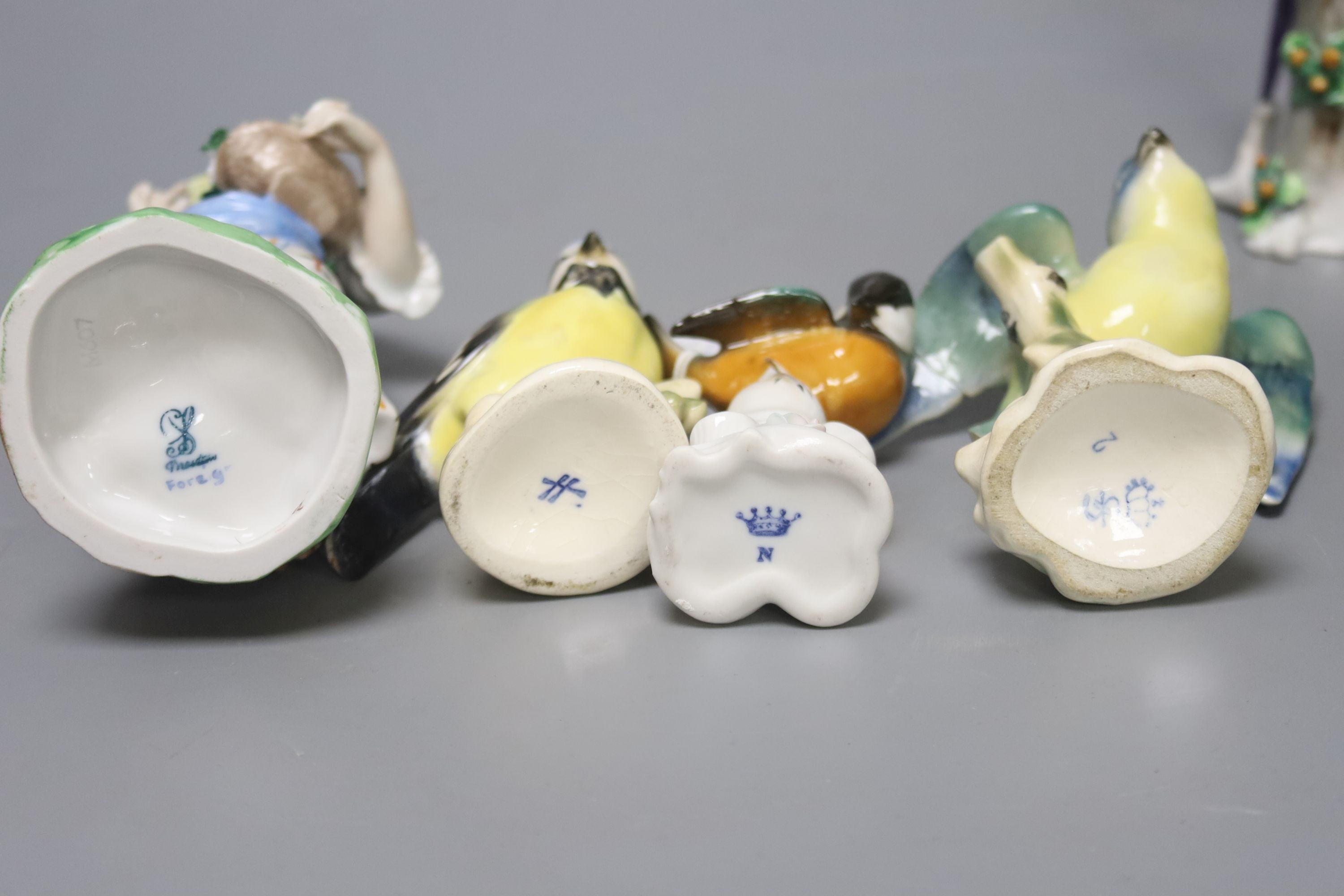 Three Continental figures and a collection of bird ornaments, tallest 22cm